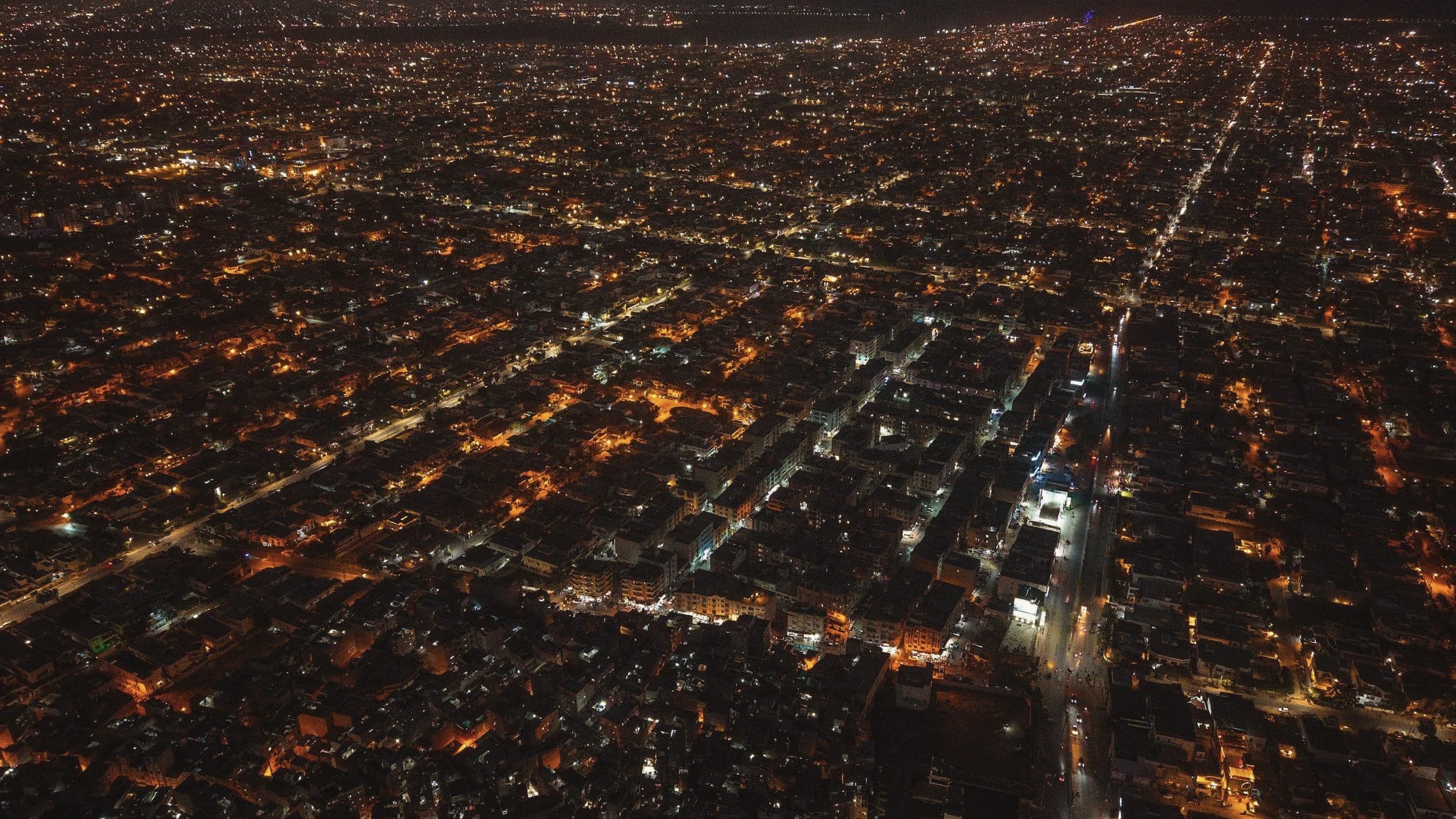 Karachi from above at night, streets traced in light